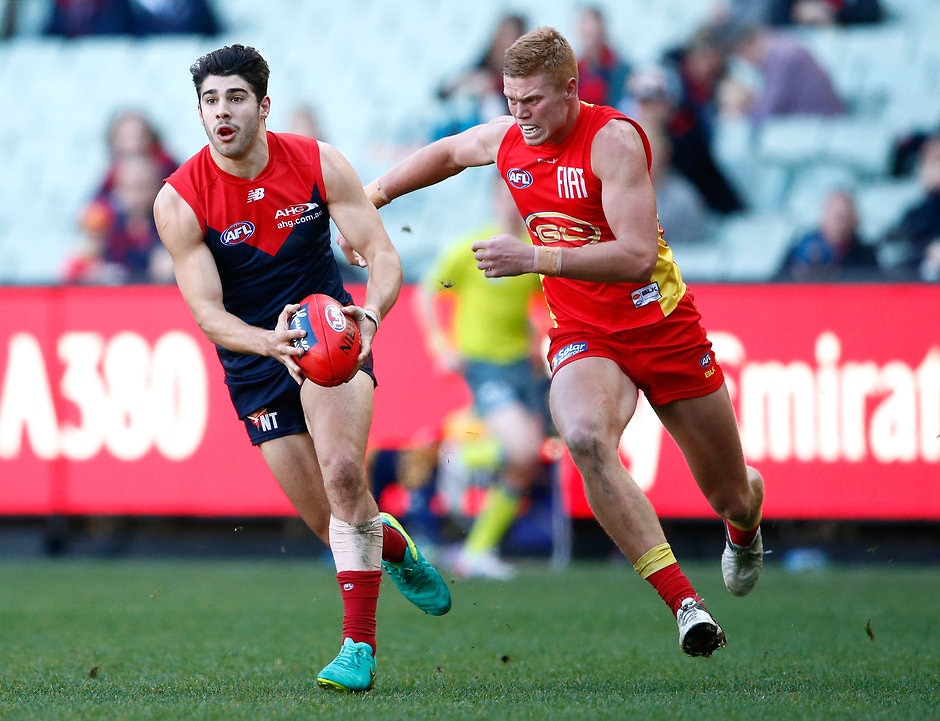 AFL 2016 Rd 19 - Melbourne v Gold Coast MELBOURNE, AUSTRALIA - JULY 31: Christian Petracca of the Demons in action ahead of Peter Wright of the Suns during the 2016 AFL Round 19 match between the Melbourne Demons and the Gold Coast Suns at the Melbourne Cricket Ground on July 31, 2016 in Melbourne, Australia. (Photo by Adam Trafford/AFL Media)